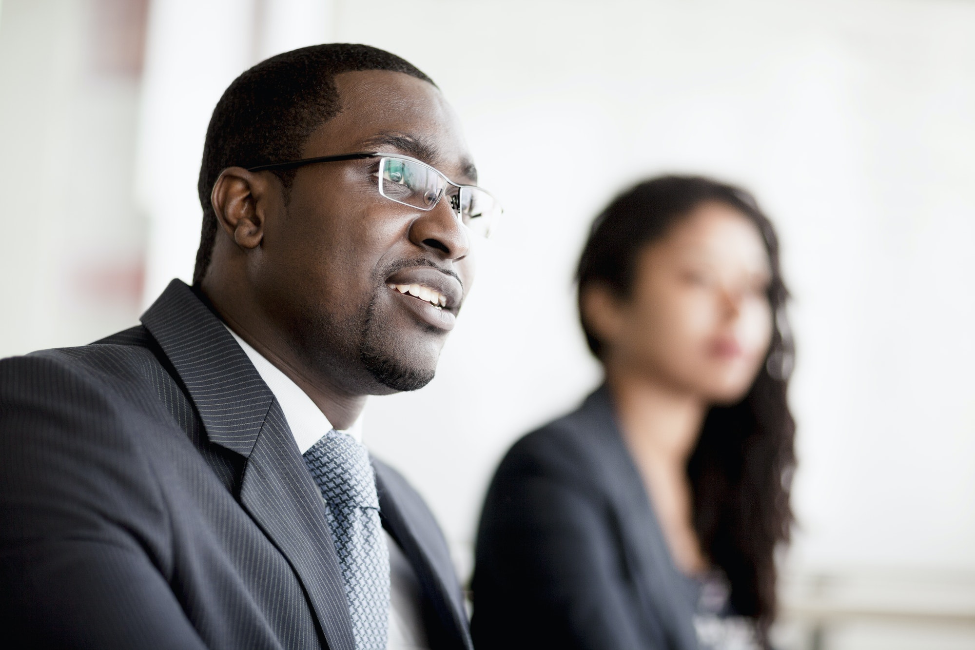 Smiling businessman listening at a business meeting